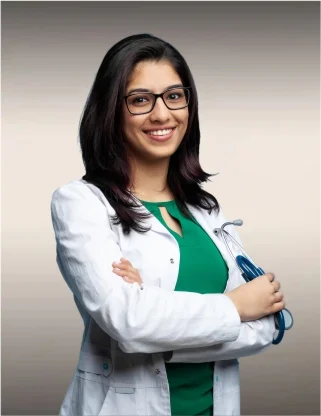 a hand holding a stesthoscope over a laptop - Best Colleges for B.Sc. Nursing